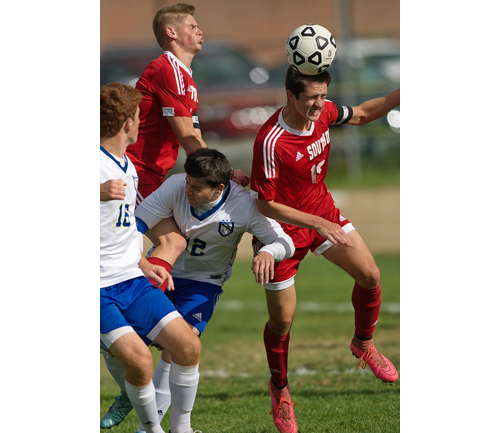 Southold's Noah Mina gets his head on the ball amid a crowd of players. (Credit: Garret Meade)