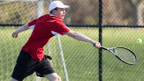 One of Southold/Greenport's first doubles players, Aidan Vandenburgh, reaching for a backhand during Tuesday's match against Eastport/South Manor. (Credit: Katharine Schroeder)