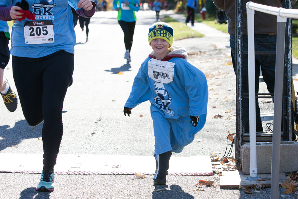 Four-year-old Grady Brigham of Southold crosses the finish line. He ran the 5K for fun and later competed in the kids' race.