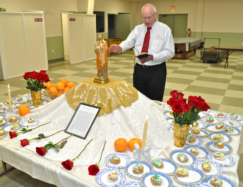 Deacon Jeff Sykes of Sacred Heart Parish blesses the traditional St. Joseph's table during the North Fork Italian-American Club's St. Joseph's Day celebration at the town recreation center in Peconic on Friday, March 25.