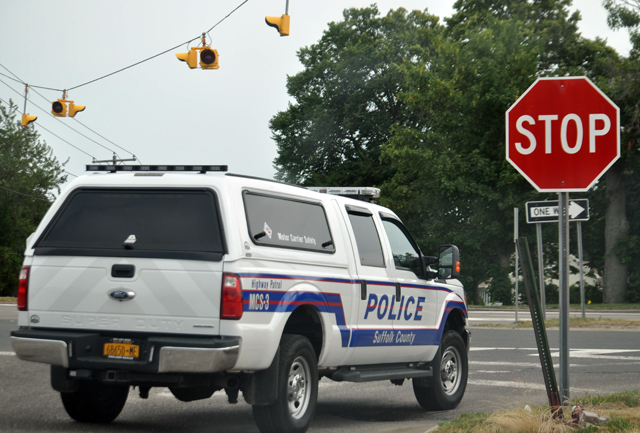 A Suffolk Police vehicle inspects the intersection at Depot Lane and Route 48 in July. (Credit: Grant Parpan, file)