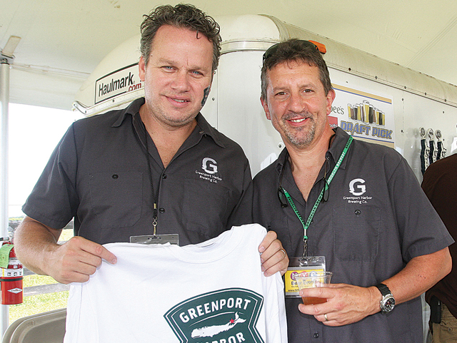 Greenport Harbor Brewing Company co-owners John Liegey (left) and Rich Vandenburgh at their booth during the beer festival this summer. (Credit: Barbaraellen Koch, file)