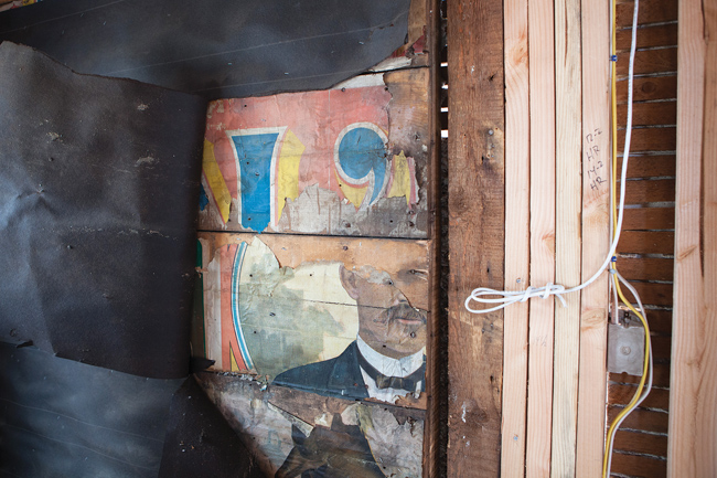 A portion of Walter L. Main's face as it appears inside the kitchen wall as the renovations continue. (Credit: Katharine Schroeder)