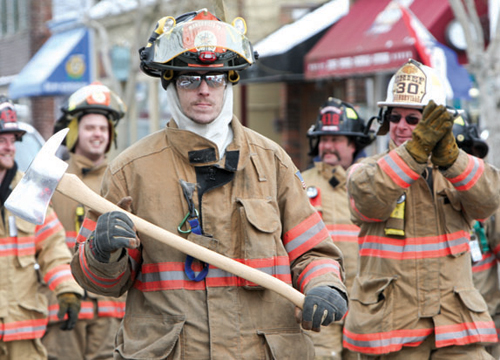 Volunteer firefighters march in a Presidents Day parade hosted by Greenport Fire Department. (Randee Daddona file photo)