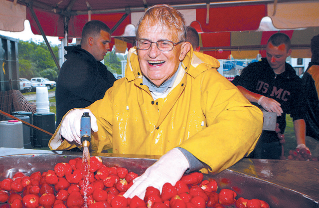 Harry Jaquillard rinses strawberries to be used for shortcake during the 2009 Strawberry Festival in Mattituck. (File photo)