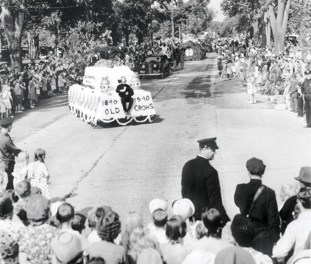 The Tercentenary parade winds its way through a packed downtown Southold in 1940.  At center is the feather-covered float of the 'Old Crows.' (Credit: Southold Historical Society Courtesy Photo)