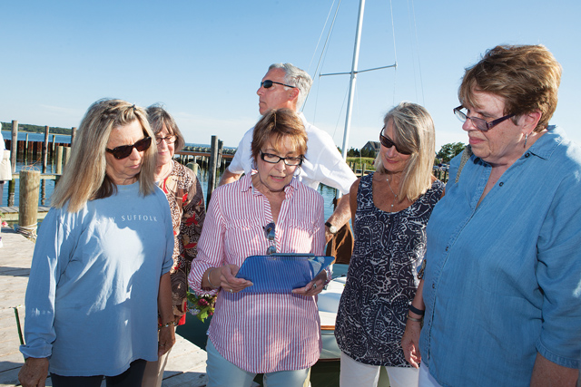Carol Dinda, second from left, reads a passage in memory of Lilly Andrews. (Credit: Katharine Schroeder)