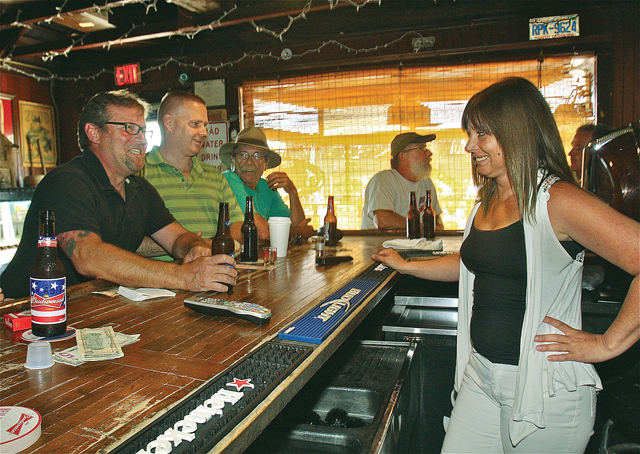 Broken Down Valise bartender Michelle Suarez (right) talks with customers (from left) Scott Nietupski, Jon Allen and Ed Grohoski on a recent Friday. (Credit: Barbaraellen Koch)