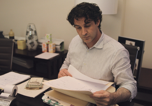 Attorney Kyle Lynch reviews his client Helen Chalmer's personal documents at his law office in East Hampton. (Credit: Jennifer Gustavson)