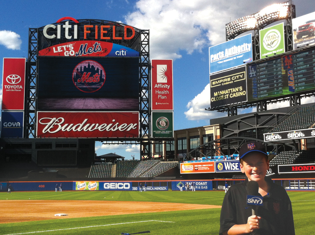 David Okula holds the SNY microphone on the field at Citi Field last week. (Credit: courtesy photo)