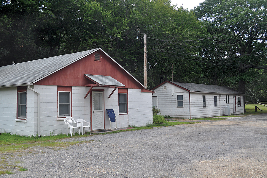 Two of four buildings that house six numbered apartments at the Cutchogue business property where town officials say people are living illegally. The buildings were described in the 1960s as being part of a 'labor camp' where farmworkers lived. (Credit: Cyndi Murray)