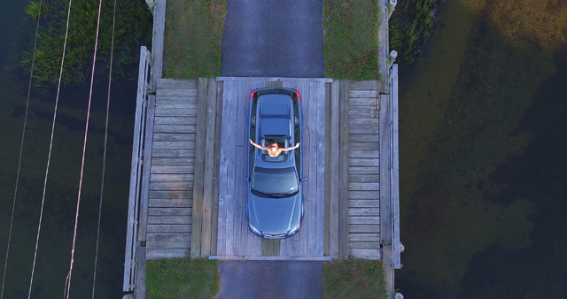 Mary Latham bursts from the sun roof of her mom's 1998 Subaru. (Credit: Jack Kohut/Lifted Sight)