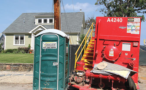 CARRIE MILLER FILE PHOTO | Equipment and a portable bathroom in front of the home of Robert and Celia Swing at the intersection of Island View Lane and Bay Shore Road. 