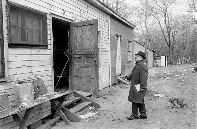 Housing for migrant workers at the camp is viewed by a member of a visiting legislative group in February 1968. (Credit: Robert Walker photo courtesy of The New York Times)
