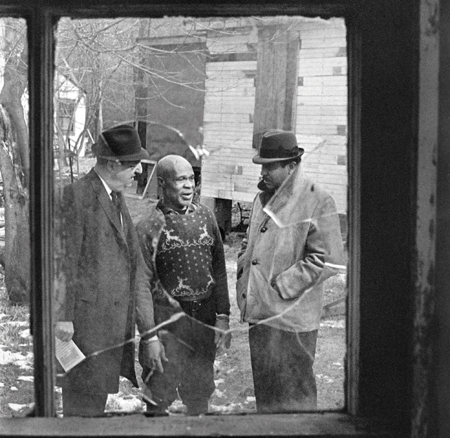 Assemblyman Stephen R. Greco, left, and Congressman Charles B. Rangell flank  a migrant worker at the Cutchogue camp in February 1968. (Credit: Robert Walker photo courtesy of The New York Times)