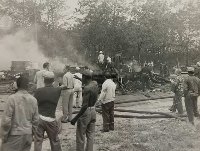 Migrant workers and fire department personnel in the aftermath of a 1961 fire that killed four at the camp. (Credit: Courtesy of the Southold Historical Society, Southold, NY)
