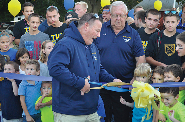 The current crop of kindergarten students in the Mattituck school district joined the high school seniors in assisting school board president Jerry Diffley as he cut the ribbon at the opening of the school track in September. (Credit: Grant Parpan)