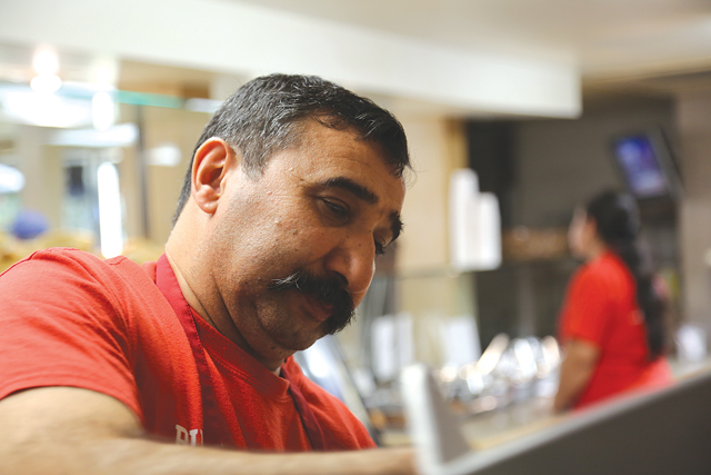 Harun 'Billy' Ilgin where you've probably seen him before, behind the counter at Wayside Market, where he always has a smile. (Credit: Krysten Massa photos)