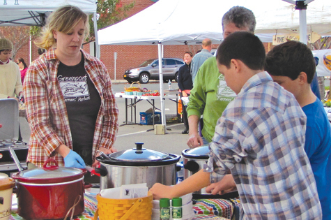 Greenport Farmers Market organizer Lara McNeil serves soup at the farmers market's old location in 2012.