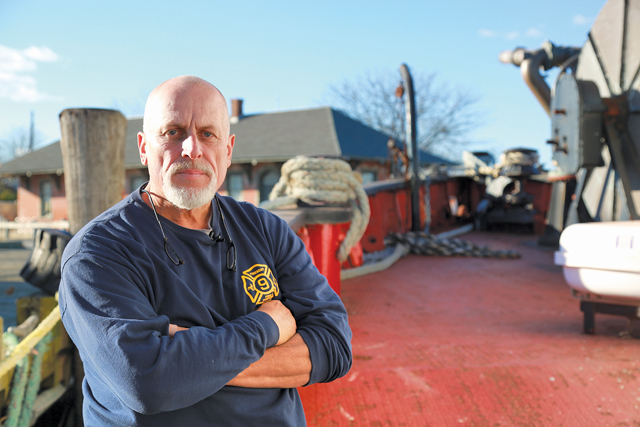 Charlie Ritchie, president of the Fireboat Fire Fighter Museum, aboard the fireboat in Greenport last week. (Credit: Krysten Massa)