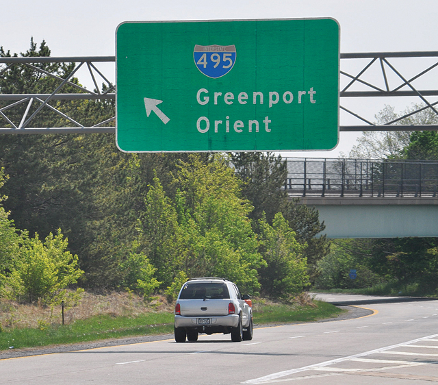 We all know the Long Island Expressway doesn't lead to Greenport and Orient — this is actually a Route 58 sign — but what you might not know is that throughout the 1950s and 1960s many local officials hoped it would. (Credit: Grant Parpan photo illustration)