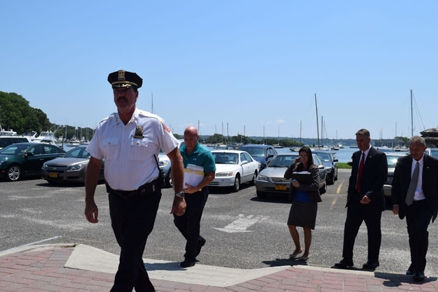 Southold Town police Chief Martin Flatley leads detectives into Eastern Long Island Hospital in Greenport for the arraignment of Steve Romeo Sunday afternoon. (Credit: Vera Chinese)