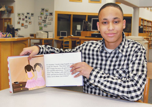 JENNIFER GUSTAVSON PHOTO | Mattituck student Terrence McKinney with the book, "Seven Days With Carole."