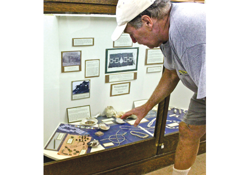 Joe Townsend shows off the Southold Indian Museum’s collection in 2012. (Credit: Beth Young, file)