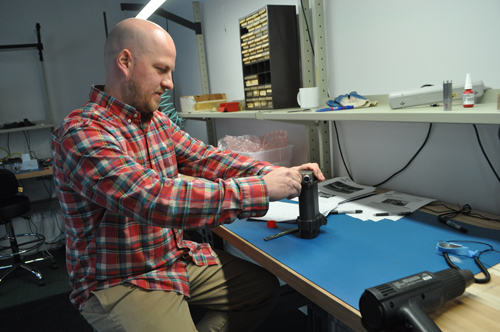 Ultra Motion owner Sean Rodger prepares an actuator for a test rig last week at the company's headquarters in Cutchogue. (Photo by Rachel Young)
