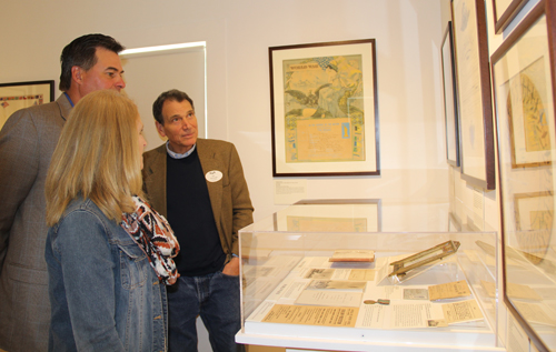 County Legislator Al Krupski learns about the wartime exhibit from Bill McNaught, museum curator.