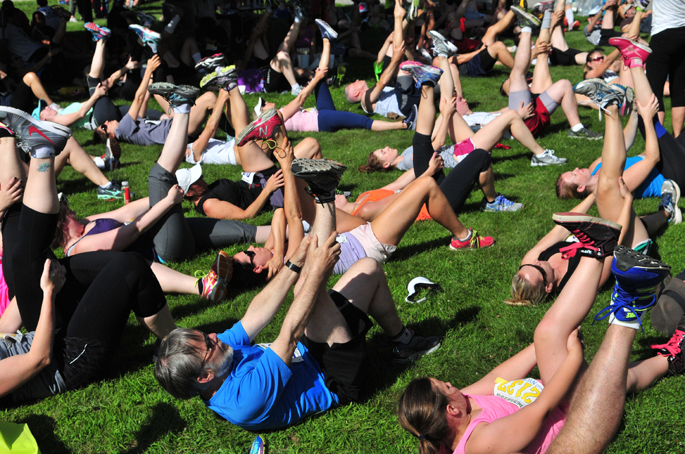 Runners stretch on the front lawn of the high school prior to the start of the 10K. (Credit: Bill Landon(