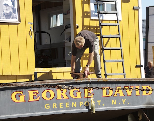 John Costello makes final preparations before launching the barge honoring his brother, the late George Costello (Cyndi Murray photos)  