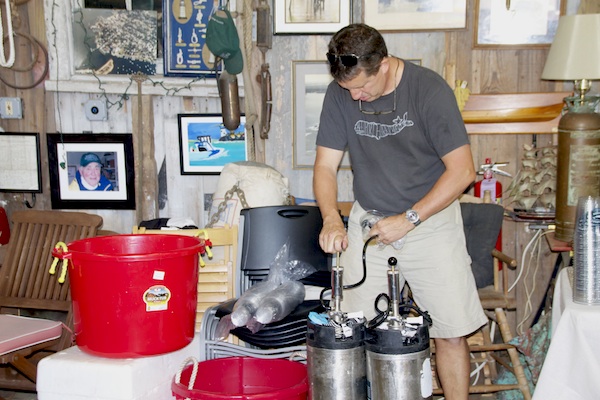Greenport Harbor Brewing Company’s owner Rich Vandenburgh taps the keg at the launch party.