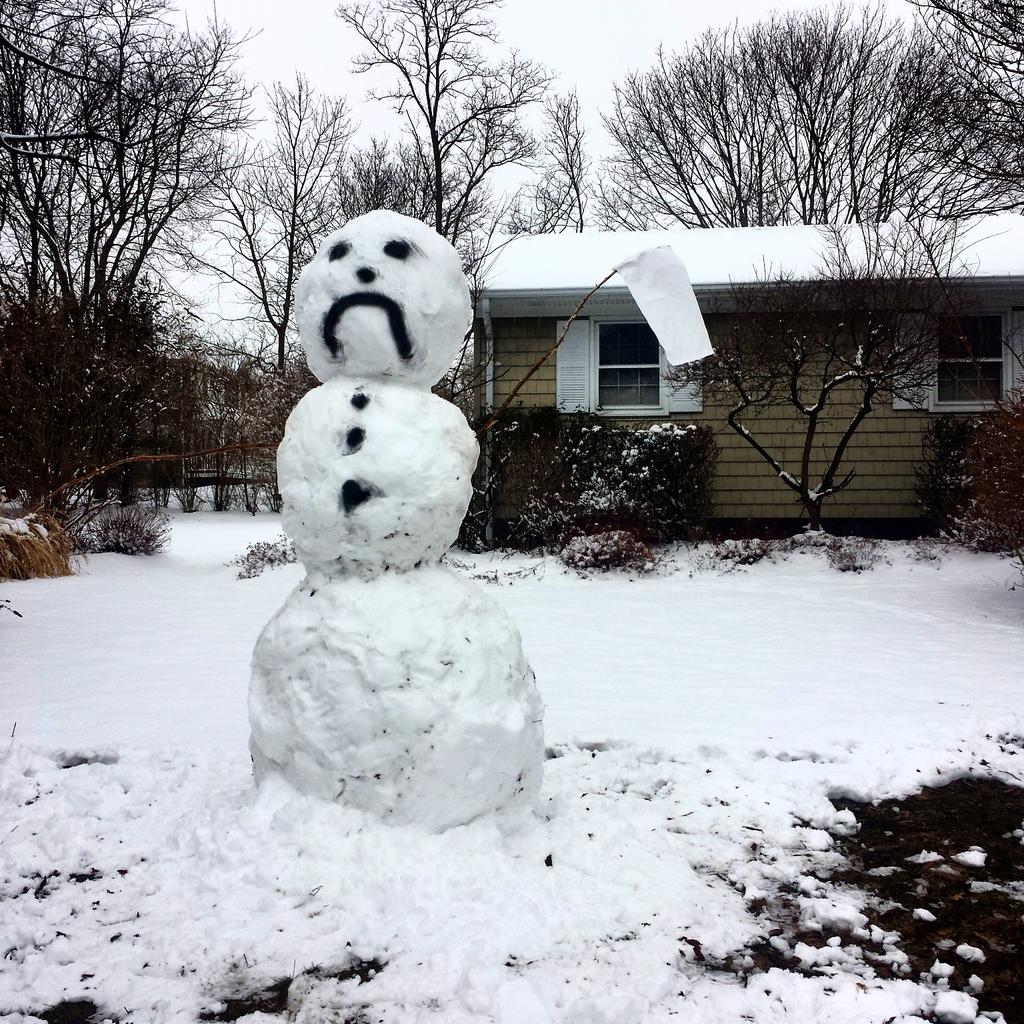 A snowman waves the white flag in Greenport. (Credit: Ryan Malone)