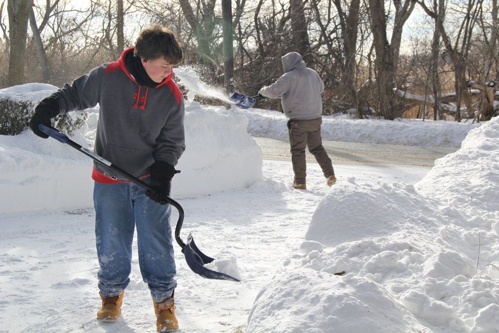 Joseph Henry, 15, and Raymond Topping, 32, cleaning up what was left behind.