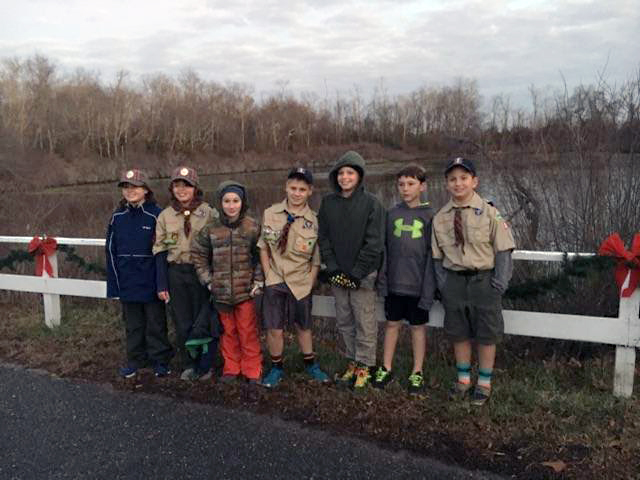 The Cub Scouts pose in front of the fence. (Courtesy photo)