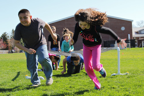 Southold Elementary School fifth graders Ronald Gonzalez and Danielle Henry make the obstacle course look easy. (Credit: Carrie Miller)