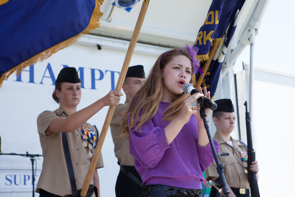 Shelby Dufton, 13, of Cutchogue sings the national anthem. (Credit: Katharine Schroeder)