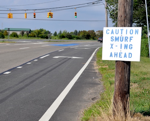 A prankster erected a smurf crossing sign after blue paint split on the roadway. (Credit: Cyndi Murrayphoto)