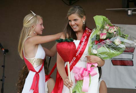 The 2010 Strawberry Queen, Veronica Stelzer, helps Kaitlyn Doorhy during her coronation as Strawberry Festival queen in 2011. (Credit: Katharine Schroeder, file)