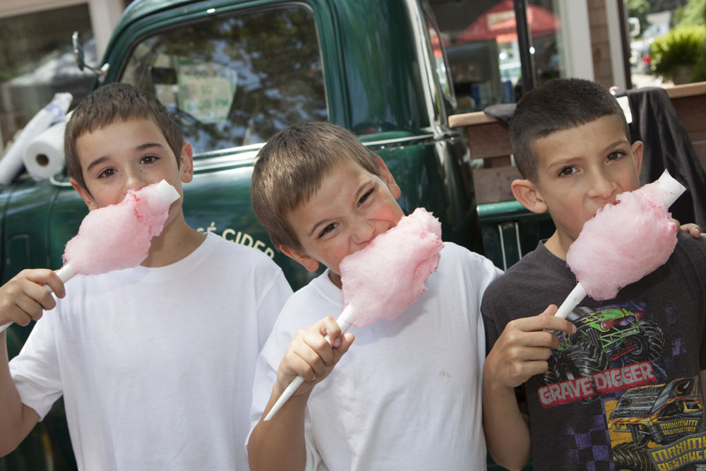 Nothing says "street fair" like cotton candy.  From left:  Nick Dombroski, 9, brother Alex, 8, and friend Jayden Martino, 8, all of Ridge. (Credit: Katharine Schroeder)
