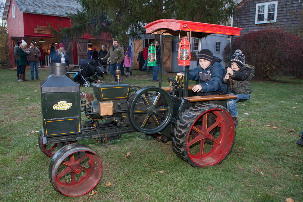 Matthew Goldberg, 9, and brother Daniel, 3,, of Merrick take a ride on a Christmas tractor.