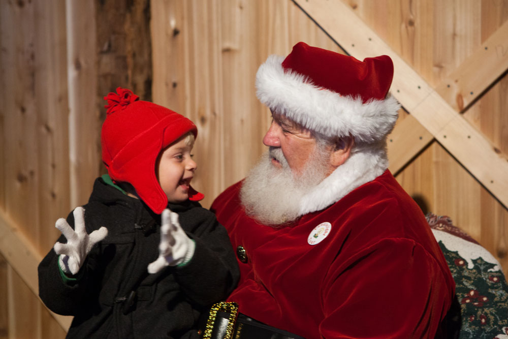 Three-year-old Evan Ford of Southold tells Santa all his Christmas wishes.