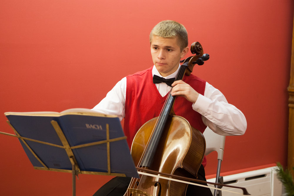 Aidan Walker, 16, of Southold, plays the cello for visitors.