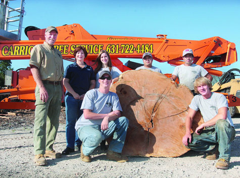 Back row, from left: Owner Kevin Carrick, office manager Karen Carrick, staff member Danielle Carrick and employees Thomas Canel and Emilio Canel. Kneeling: brothers Joshua (left) and Brian Carrick.